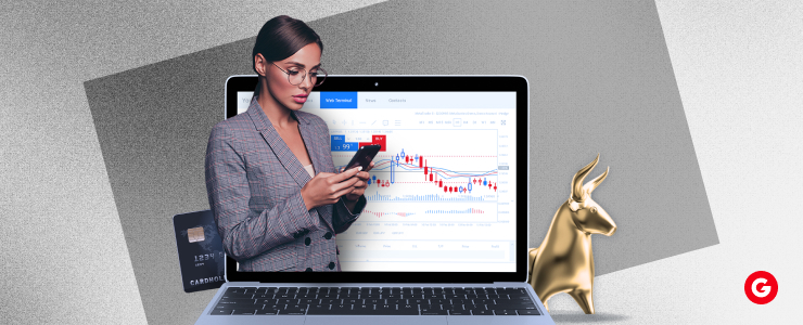 Professional woman analyzing forex charts on a laptop and smartphone, symbolizing trader strategy adjustments during the election cycle.