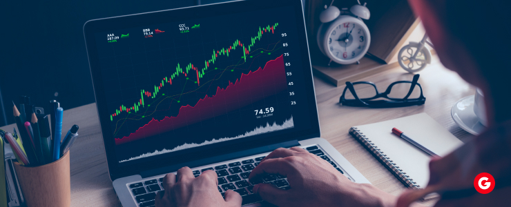 Person analyzing forex heatmap statistics on a laptop showing rising EUR/USD trading charts and market data