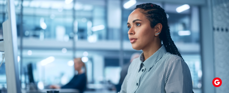 “Focused forex analyst studying high and low yield currencies on a computer in a modern trading office.